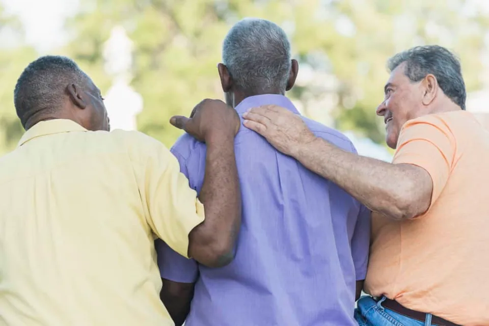Elderly men embracing each other