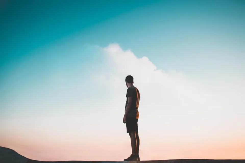 Man standing looking at the clouds