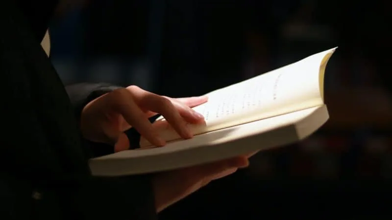 Man turning the page of the Bible