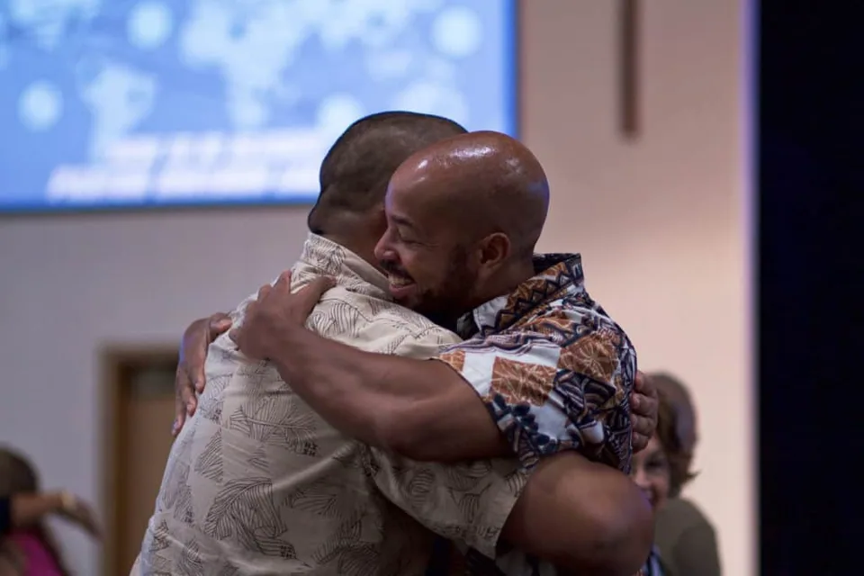Two brethren embracing each other