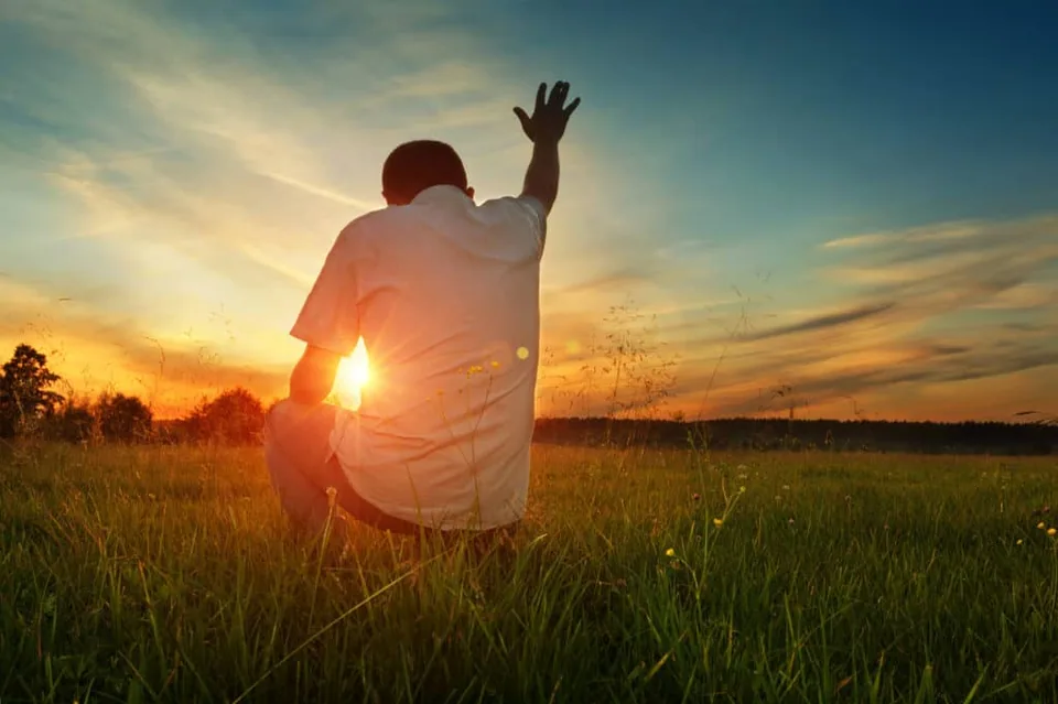 A man lifting his hands to God