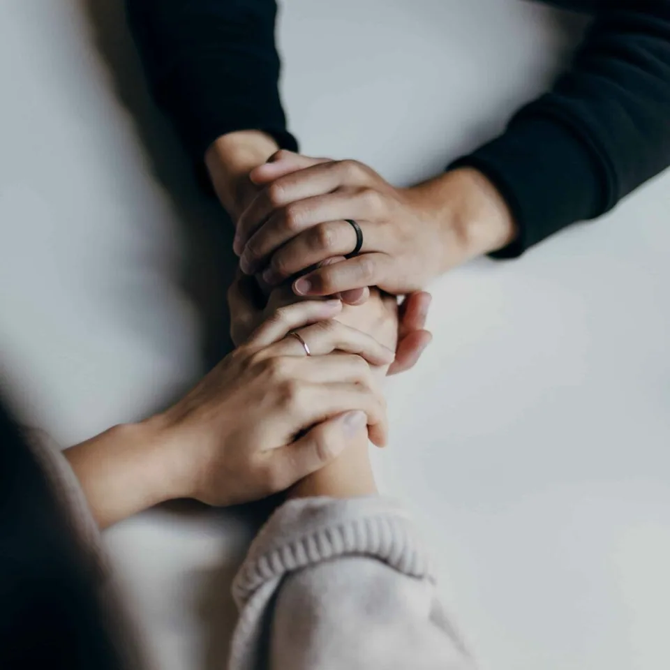 Two hands holding each other in prayer