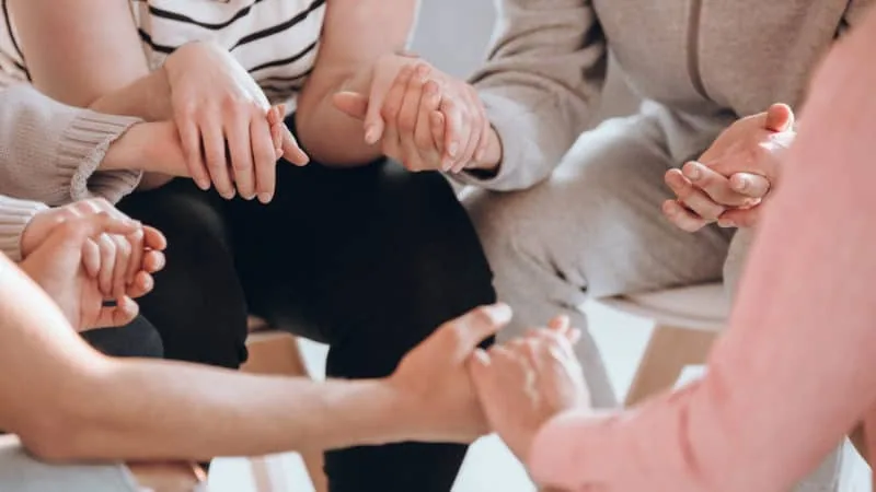 A group of people holding hands