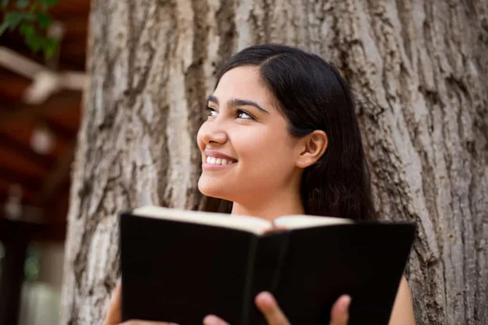 Smiling lady holding a Bible