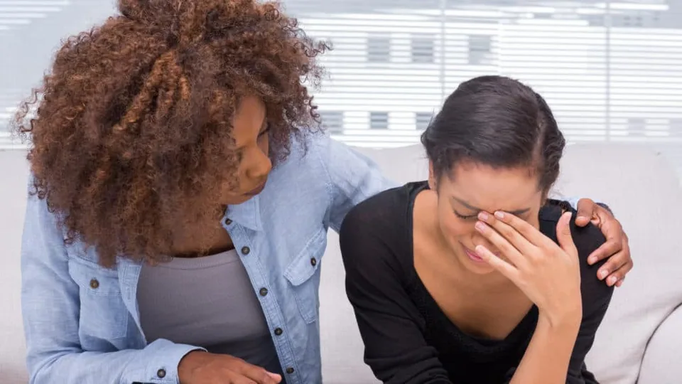 A woman comforting another woman