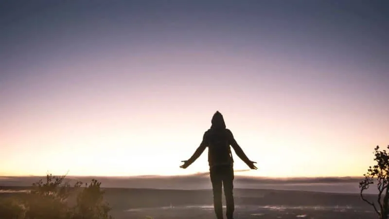 Man lifting hands in worship and looking at the sky