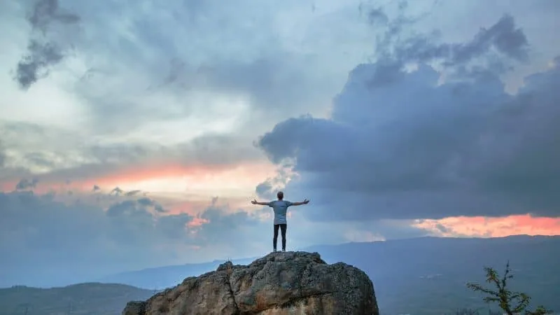 A man lifting his hands towards the sky